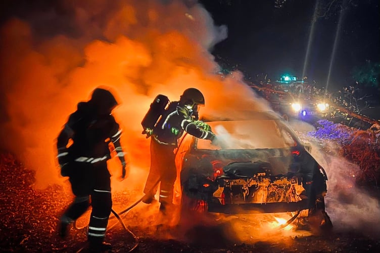 Firefighters from Bordon fire station put out a car fire in woods off Louisburg Avenue, Bordon, at 9.48pm on October 31st 2022. 