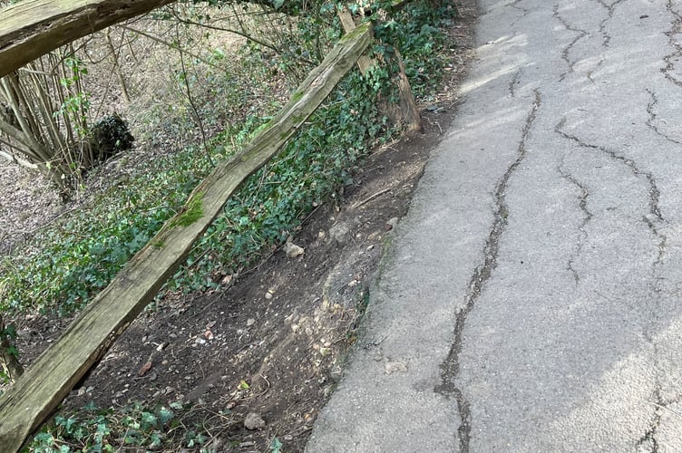 A section of the diagonal path across Farnham Park is slowly disappearing into a sinkhole