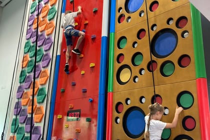 Ukrainian children go up the climbing wall at Alton Sports Centre