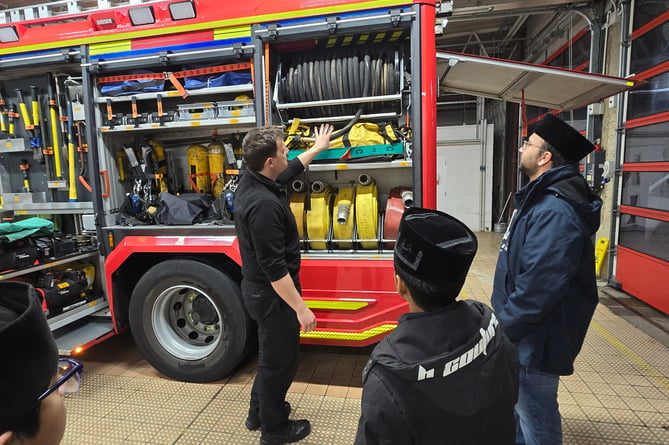 Firefighters meet members of the Ahmadiyya Muslim Youth Association.