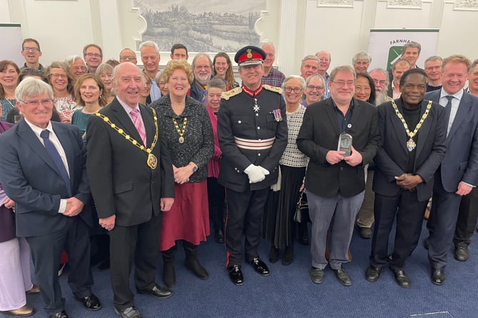 Volunteers and trustees of Farnham Repair Cafe receive the King's Award for Voluntary Service.